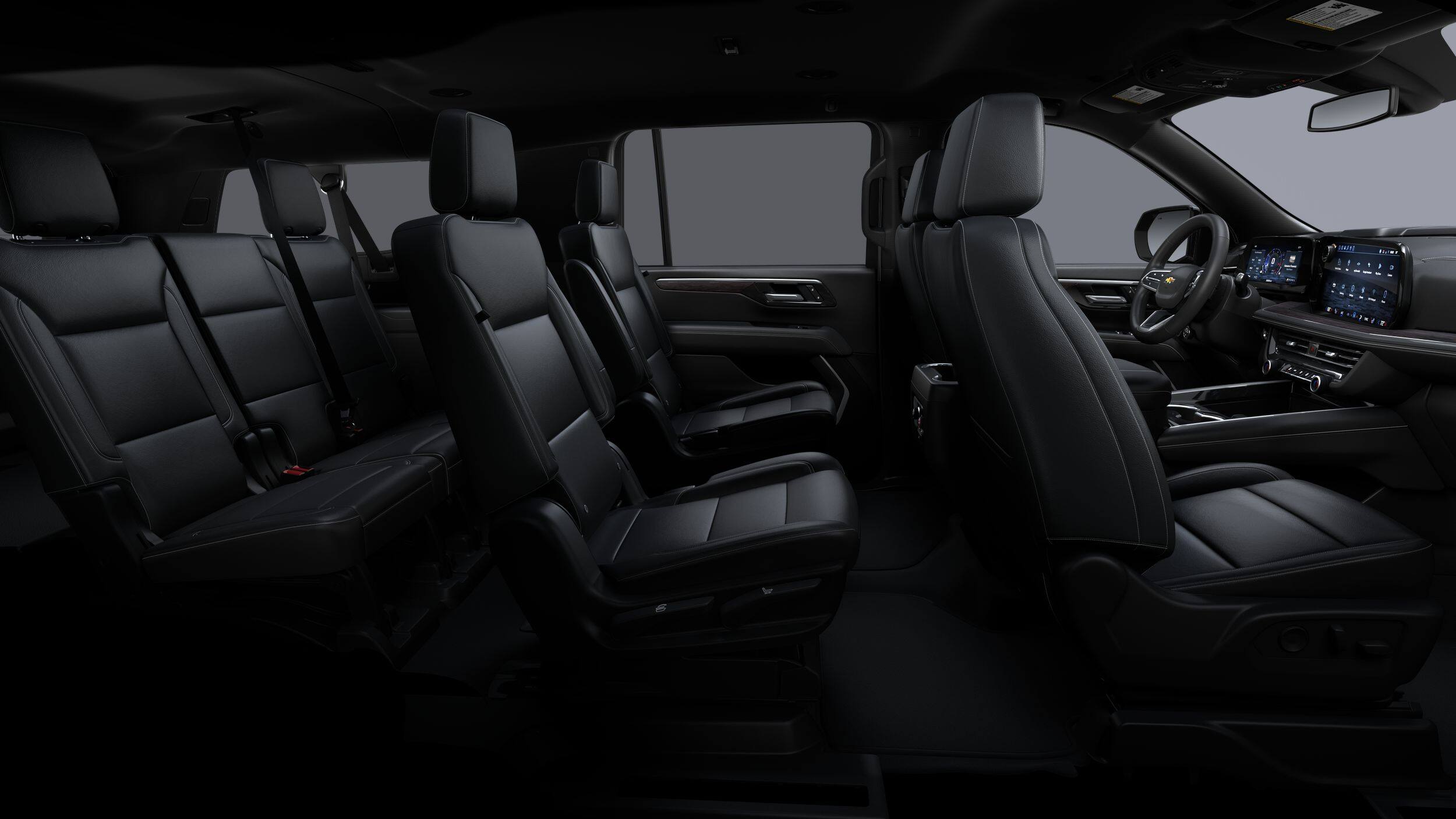 Suburban interior — black leather captain's chairs with full third-row seating